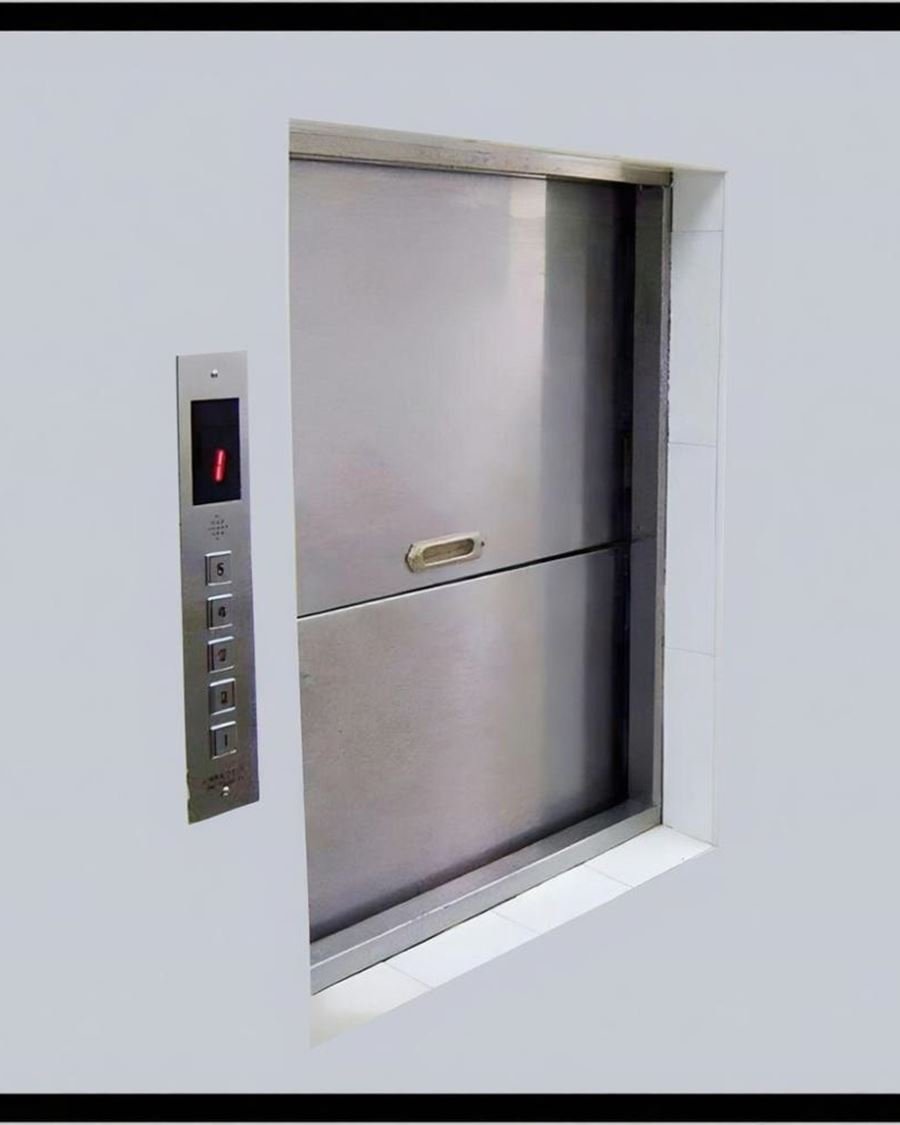 A stainless steel dumbwaiter service lift set into a wall